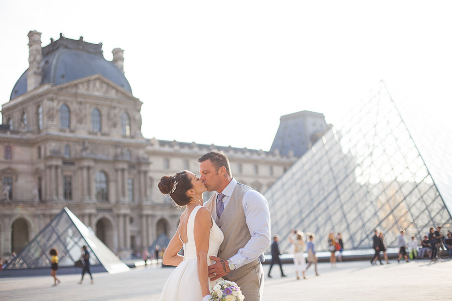 Vow renewal photoshot after the ceremony, Louvre Pyramid in Paris
