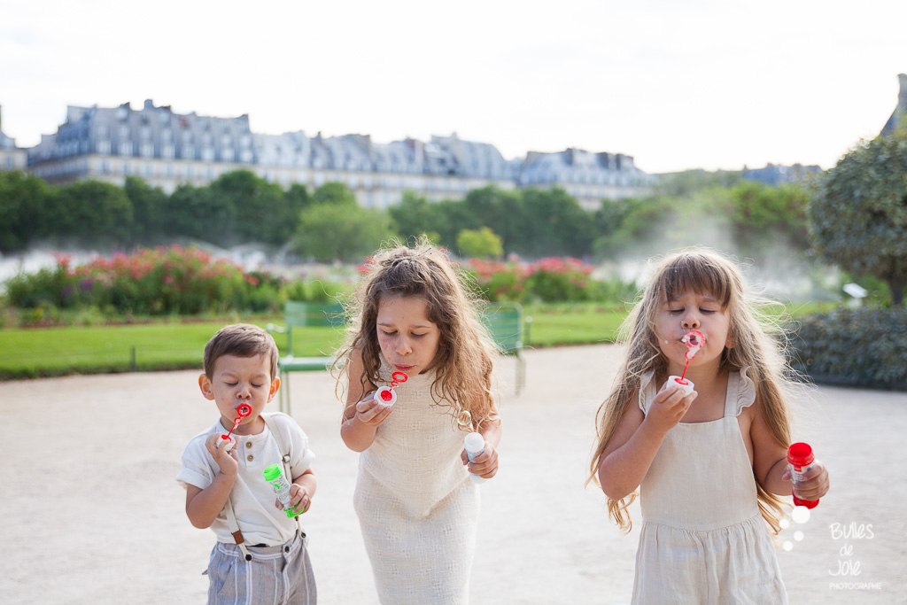 Children blowing bubbles during a family photoshoot